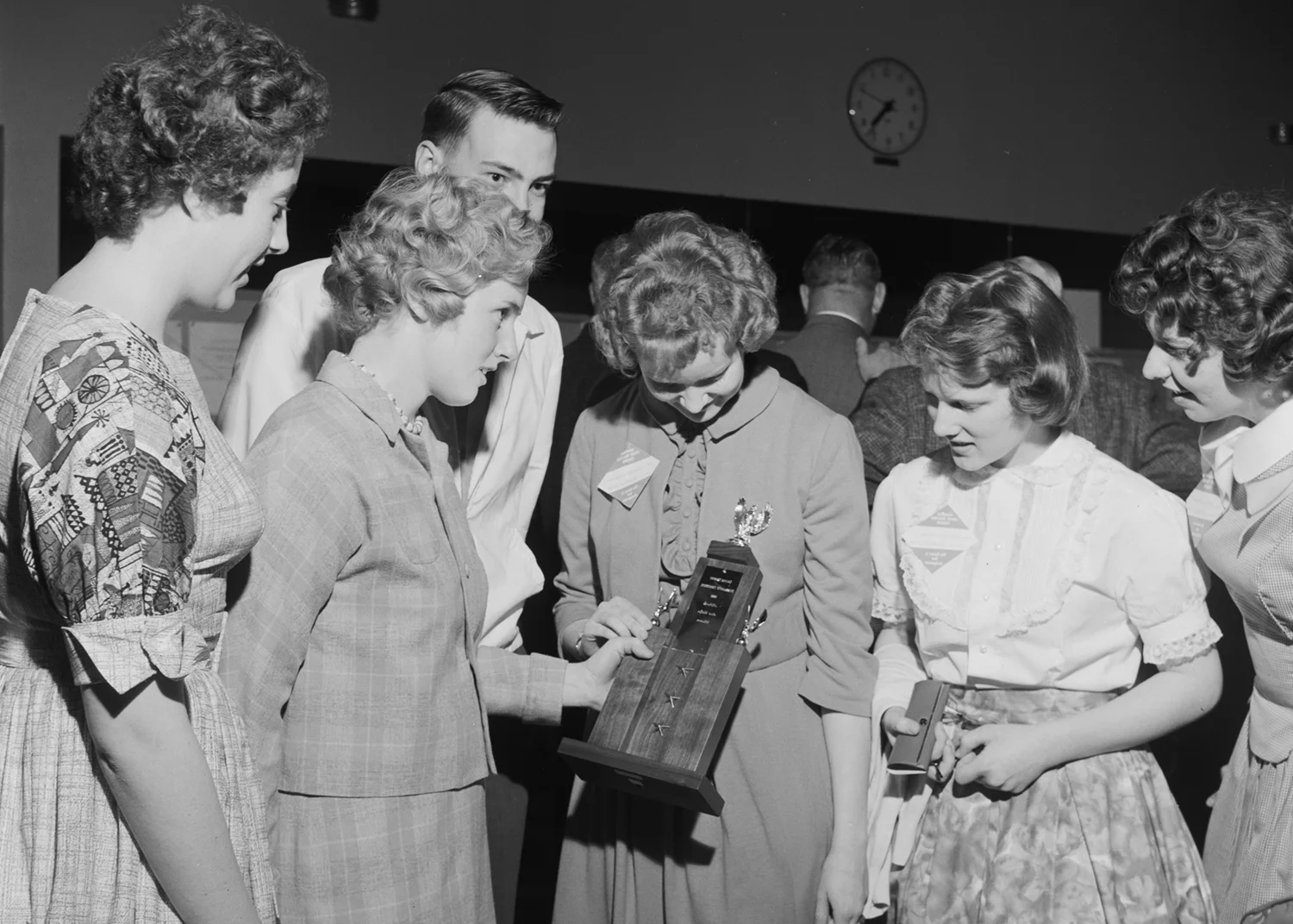 Students examining a trophy