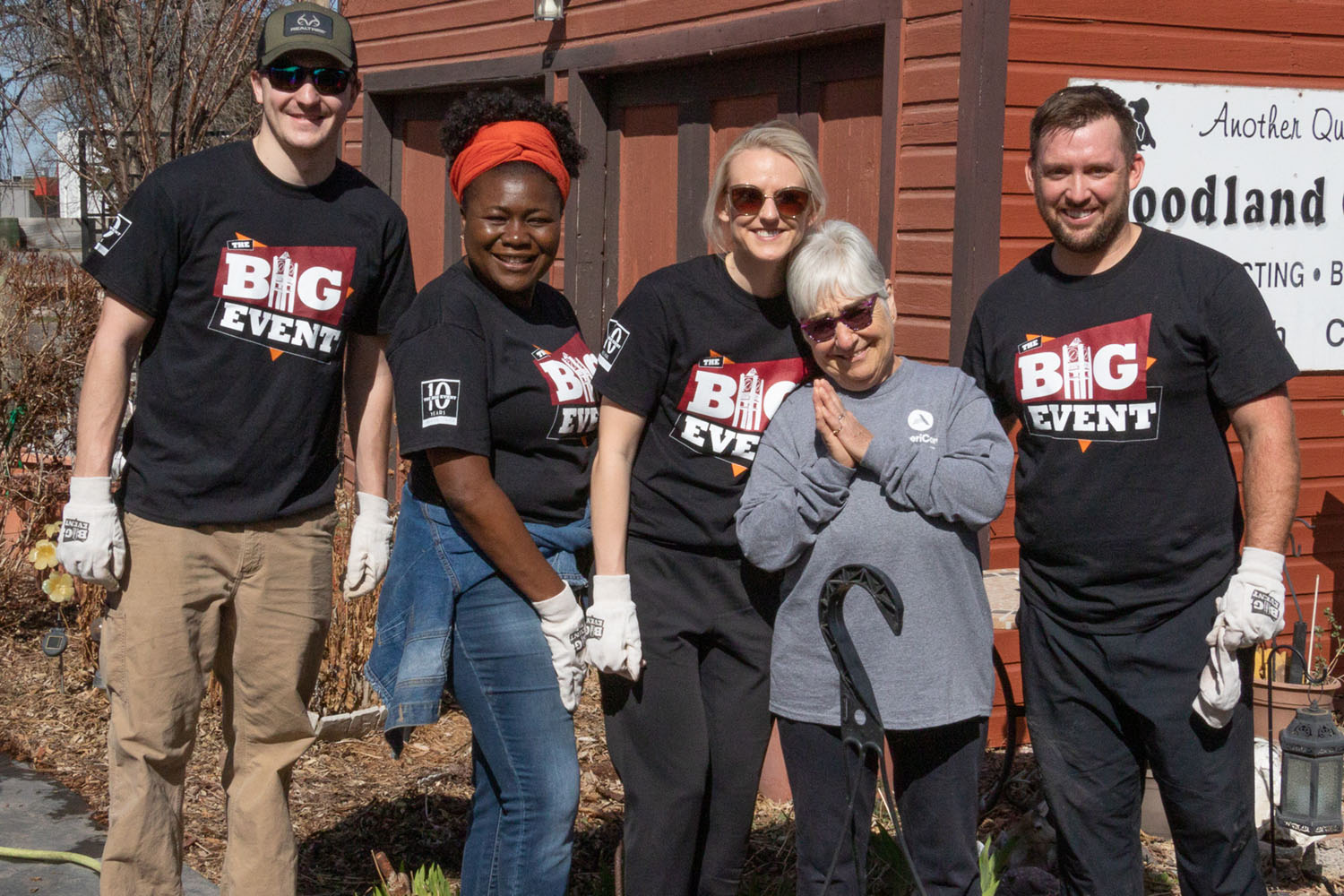 Four Big Event volunteers pose with the owner of a jobsite