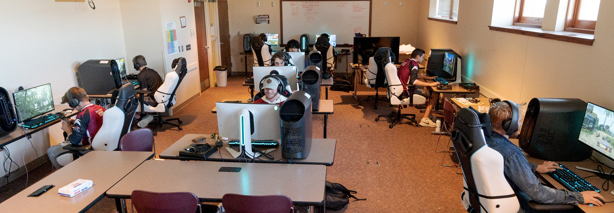 Students playing games at computers in Esports room