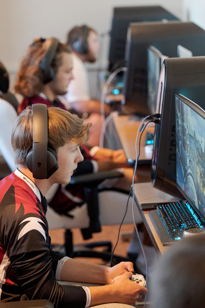 Three students playing games at computers