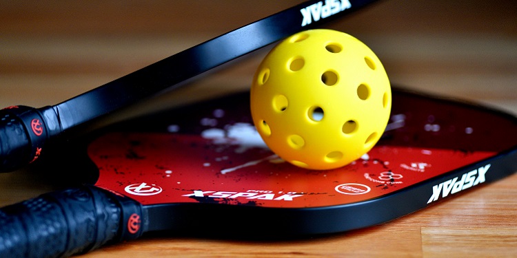 Wiffle ball and two paddles to play a game