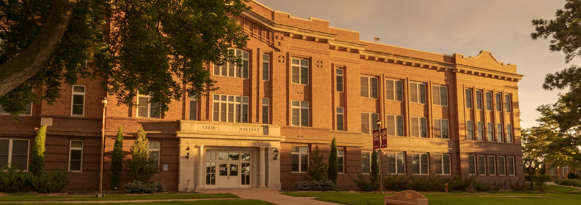 Late evening light on a three-story brick academic building
