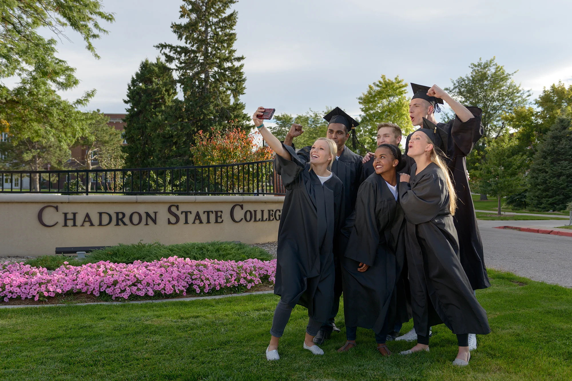 Students celebrating in graduation regalia