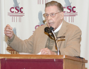 Dr. Harry Holmberg leads the crowd in 