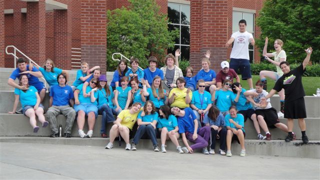 Upward Bound participants gather with Chadron State College student leaders at the base of the Lindeken Clocktower.