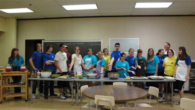 Participants of the Upward Bound program display cuisine they prepared during a cooking class taught by Dr. Jay Sutliffe.