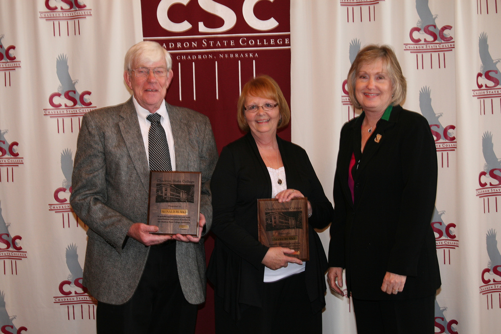 Ronald and Mary Burke, at left, with the plaques that were presented by President Janie Park.