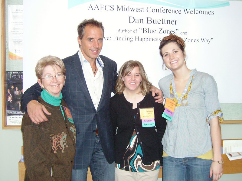 Norma Nealeigh, Bethany Seifert and Samantha Fields pause for a photo with author Dan Buettner.