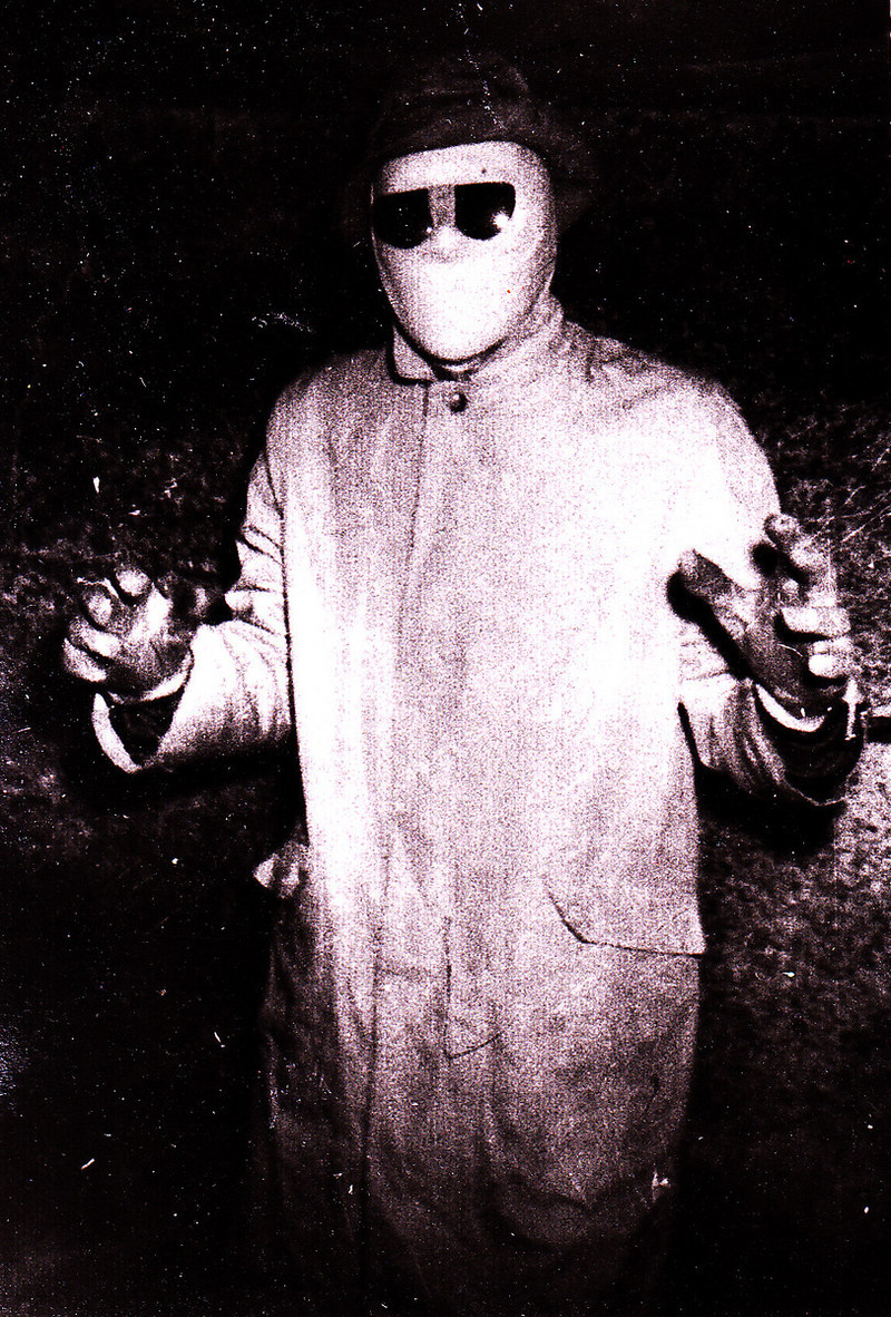 The Phantom poses for one of his original photographs, which was taken in an apartment's coal bin.