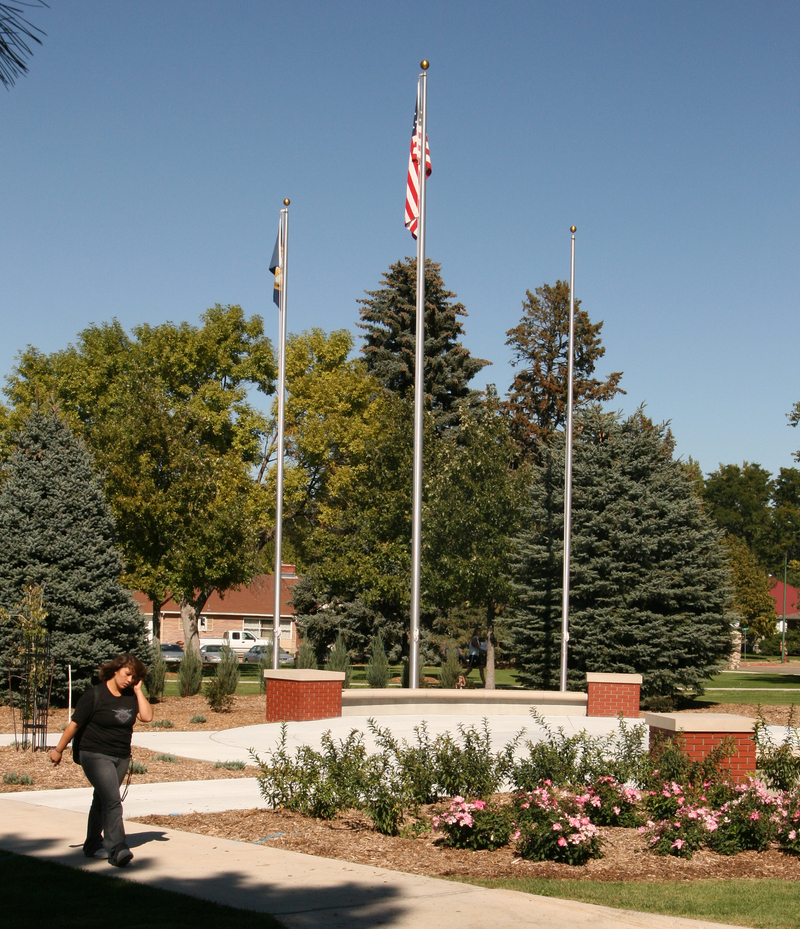A student walks past the new flag plaza on the Dean's Green.
