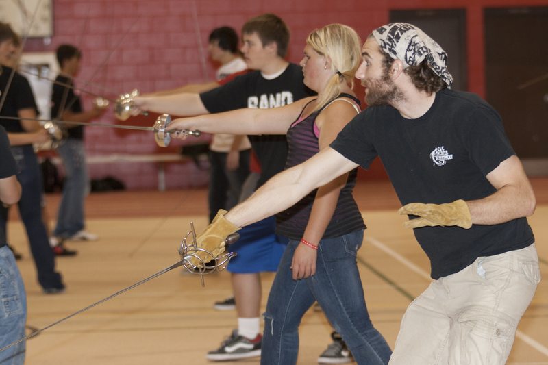 Mason Quinn, a Chadron State College theatre student, helps show the art of stage combat during a Theatre Day session in the Nelson Physical Activity Center.