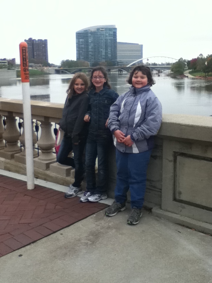 Abby Hyer, Claire Margetts and Maggie Hughes stand near the Scioto River during their trip to Columbus, Ohio.