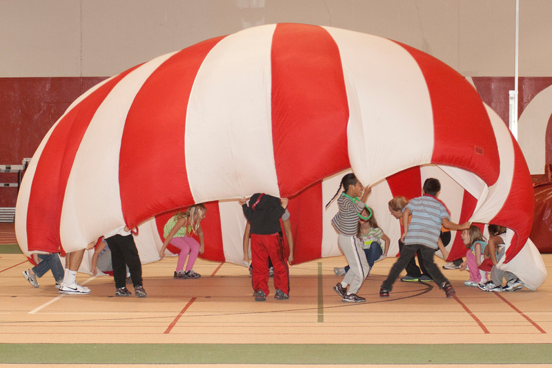Chadron third-graders participate in a parachute activity during Dance for the Health of It.