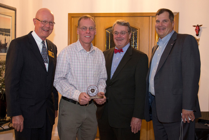 Mike Leite displays the 2011-2012 Teaching Excellence Award. He is accompanied by Gary Bieganski, Stan Carpenter and Randy Rhine. (Photo by Justin Haag)