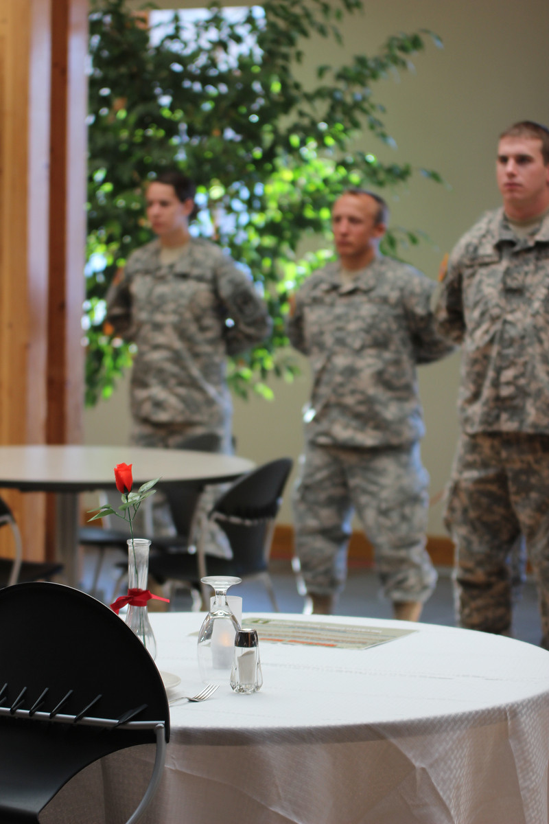 The missing man table serves as a fitting tribute to soldiers missing in action as Chadron State College ROTC cadets stand nearby. (Photo by Justin Haag)