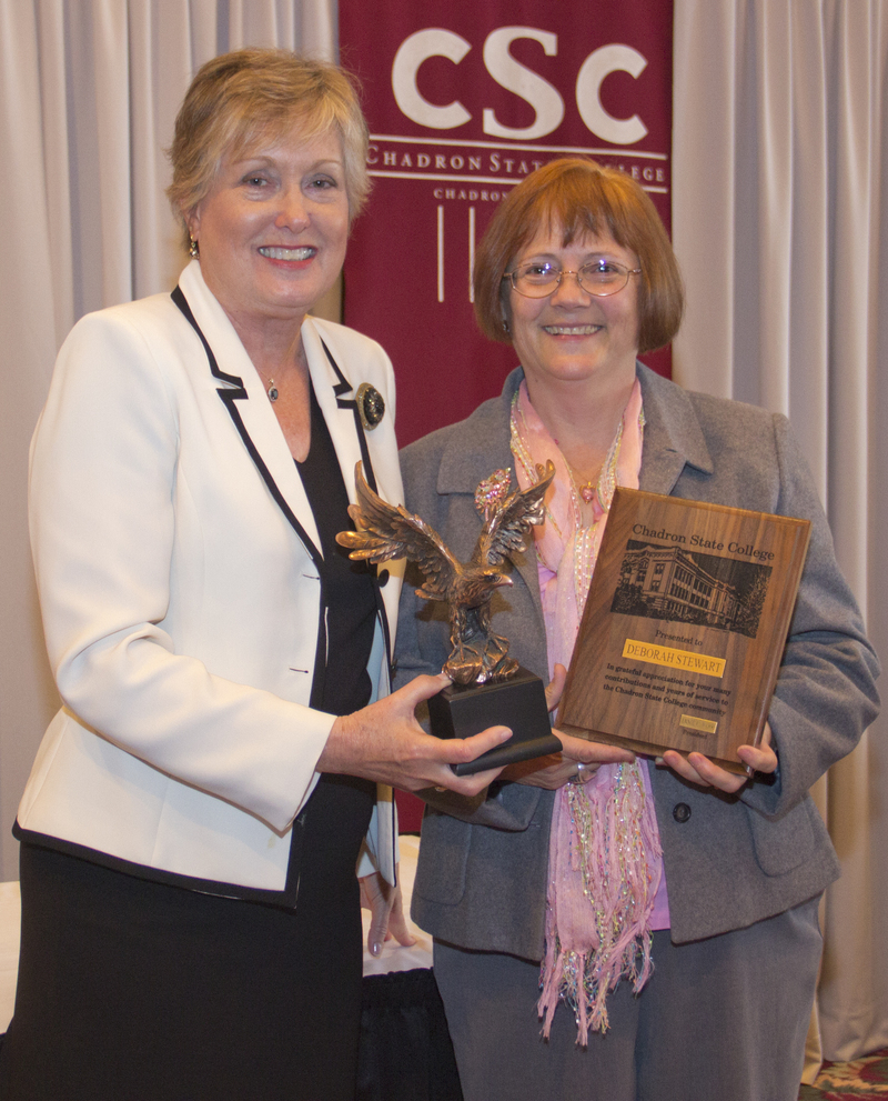 Deb Stewart, one of two retirees, receives her plaque and gift from President Janie Park. (Photo by Justin Haag)