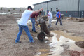Jake Brunette empties gravel from a wheelbarrow