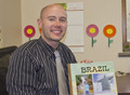 Jesse Sealey with a scrapbook of his trip