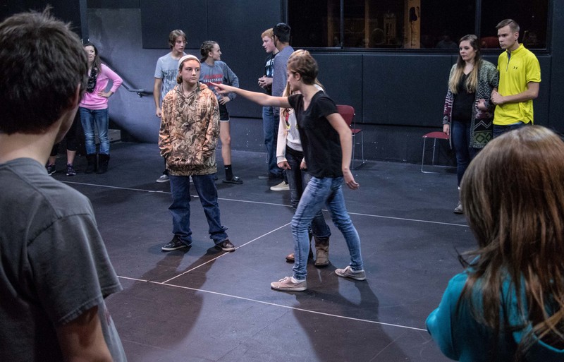 Syerra Wycoff-Bagshaw gives instructions to high school students attending a games workshop.