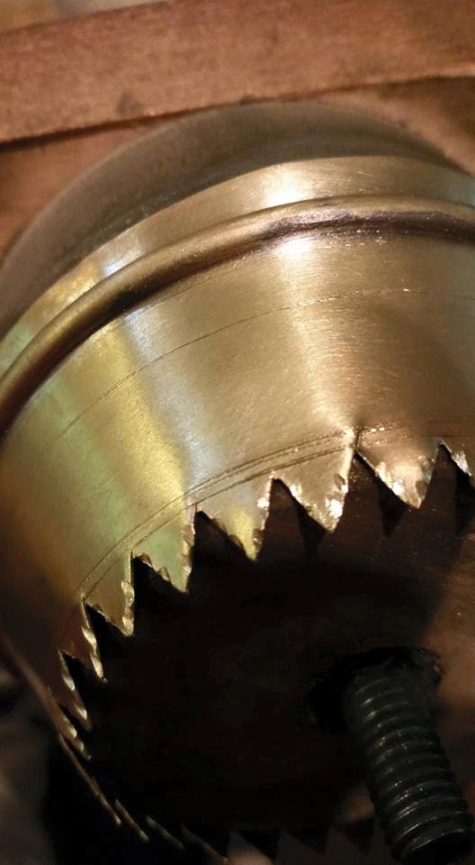 Hand tools are used to make cuts in the brass pieces that form the trumpet.
