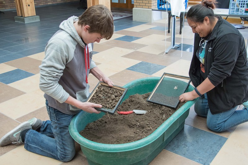 Karsen Hunter and Oshie Shizzle participate in a replicated archaeology dig