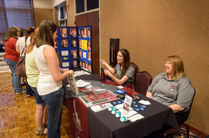 Lisa Curtis and Jen Schaer speak to prospective students at a Chadron State College on-campus registration session.