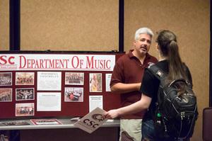 Dr. Michael Stephens speaks to a prospective student during a past on-campus registration session.