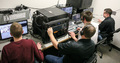 Members of the CSC Live production crew run a women's basketball broadcast