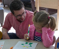 Travis Hencey encourages Lillian Johndreau to draw