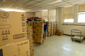 Karma Schefcik moves cases of toilet paper