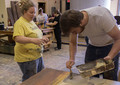 Amy Campion instructs Leo Haselhorst in set painting
