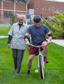 Dr. Marv Neuharth assists student on the reverse steering bikes