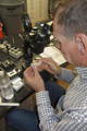 Mike Leite examines fossil through microscope