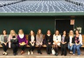 CSC students pose in a dugout in Omaha