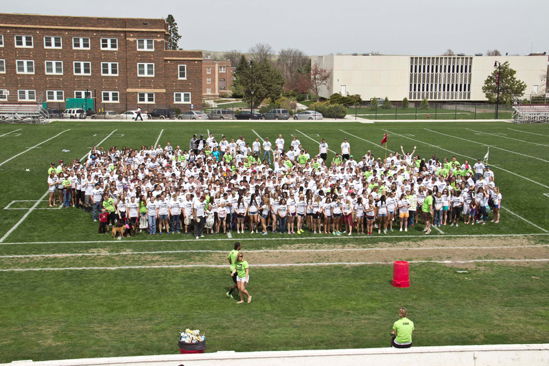 Several hundred Chadron State College students, faculty and staff volunteers gather for a group photo on Elliott Field prior to departing to over 50 work sites in Chadron, Crawford and other area locations in 2014.