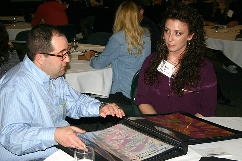 Chadron State College student Rachel Blair of Hubbard, Nebraska, right, listens as she receives a critique of her portfolio by a professional at the Omaha chapter of American Advertising Federation's Meet the Pros conference in Omaha Feb. 20-21, 2017