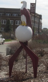 A sculpture depicting an eagle on a globe is among the pieces of the CSC art collection that are displayed outdoors