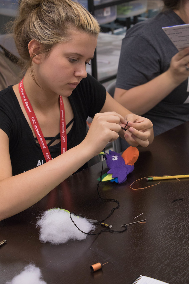 Summer Upward Bound student Cherokee Parviance of Alliance, Neb., stitches a plush toy in art class.