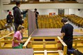 CSC Theatre cast remove the hardware holding the stage together