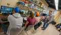 Student volunteers sit and work on experiment