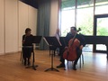 Three people performing musical instruments