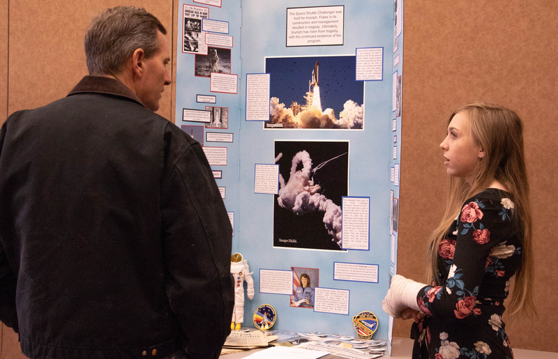 Kamden Victory, of Crawford, right, explains her exhibit to a visitor during Western District History Day at Chadron State College Friday, March 1, 2019. (Tena L. Cook/Chadron State College)