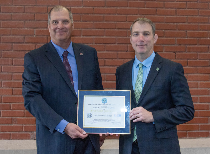 Dr. Randy Rhine, President of Chadron State College, left, and Dr. Paul D. Turman, Chancellor of the Nebraska State College System, pose with the Chair's Outstanding Performance Certificate presented to Chadron State College April 26, 2019, at the Nebraska Employer Support of the Guard and Reserve Awards Banquet in Lincoln.