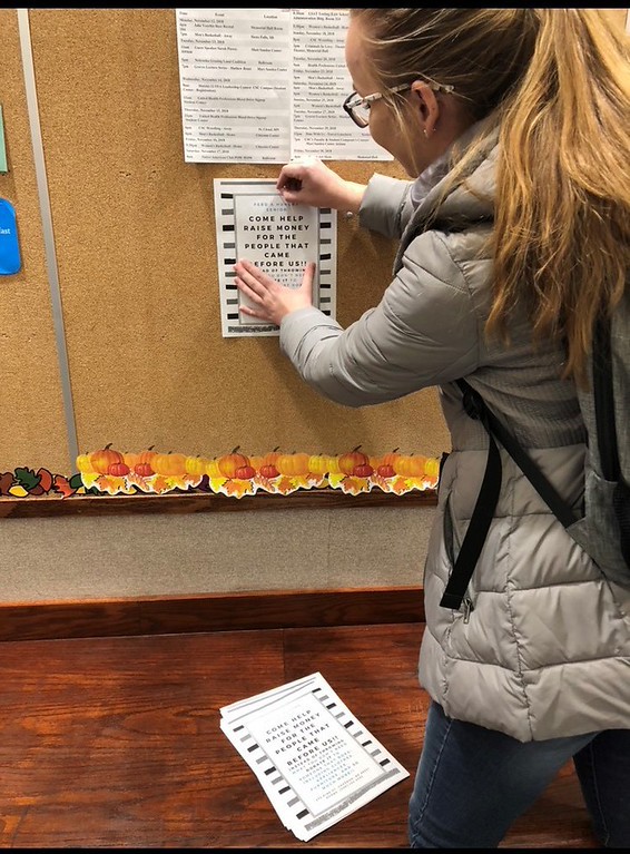As part of a First Year Inquiry class about service learning, Chadron State College student Madisen Grenstiner of Wasta, S.D. posts a flyer