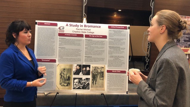 Chadron State College student Rachel Mitchell, left, speaks about her research poster with a professor at the North American Victorian Studies Association in Columbus, Ohio Oct 19, 2019.