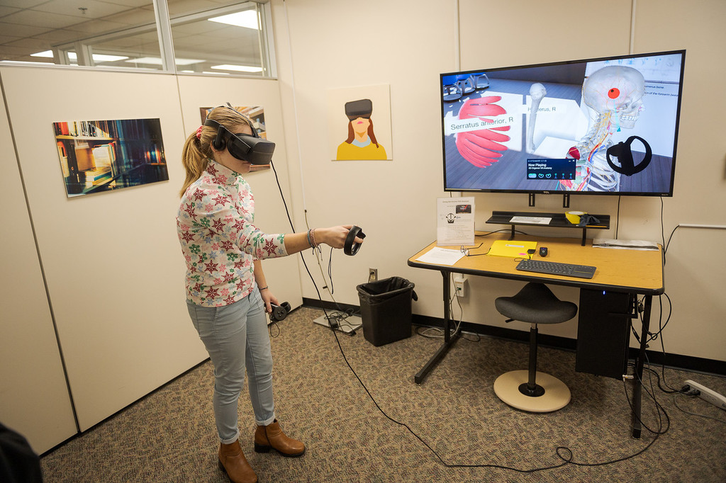 Mackenzie Helm uses the virtual reality system in the King Library to explore the human body in an anatomy application. Helm is an education major learning how virtual reality systems can be used in the classroom.