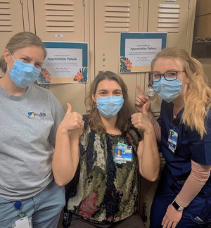 Tierra Schroeder poses with coworkers while volunteering for The Big Event