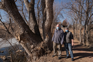 Lucinda Mays and Steve Rolfsmeier stand with a peachleaf willow at Briggs Pond