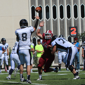 Collin Eisenman (94) rushes Colorado School of Mines quarterback Justin Dvorak (8) during their game Sept. 20, 2014