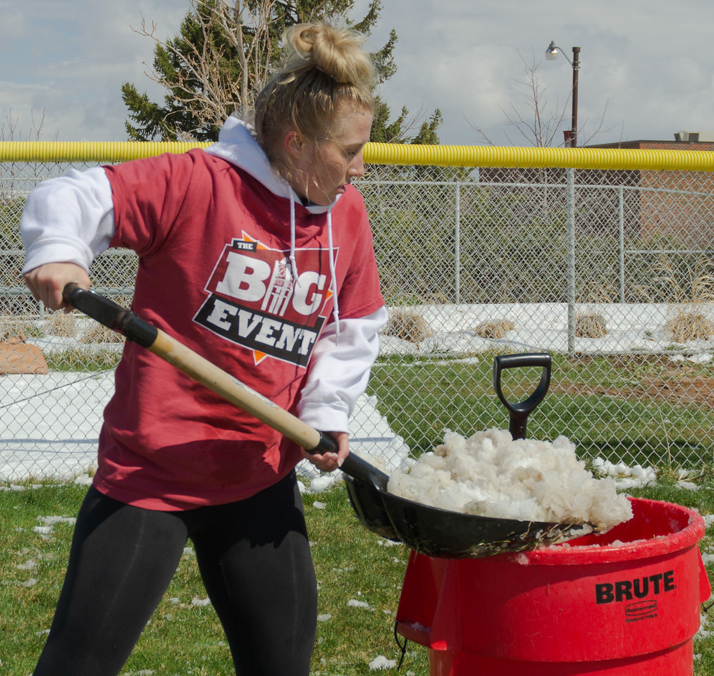 Bailey Brooks shovels snow off the softball field during The Big Event